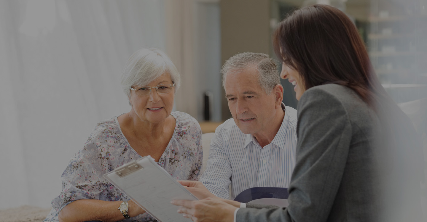 Elderly patients talking to a financial advisor about a payment plan for their hospital bills