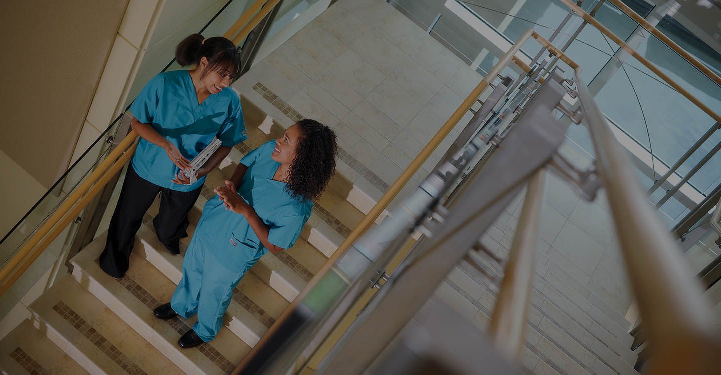 Nurses walking down the stairs in the AdventHealth for Women main lobby