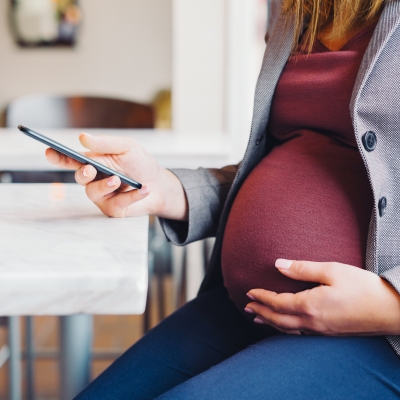 Pregnant woman on a smartphone.